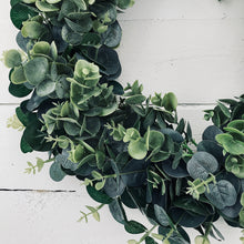 Load image into Gallery viewer, Beautifully simple and chic faux Eucalyptus Wreath in a farmhouse style completed with a rustic hessian bow. Perfect for Autumn or Winter decor. Place on your front door or hang inside your home.