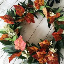 Load image into Gallery viewer, Autumn Wreath Rich russet maple leaves and lush green laurel, sprinkled with wild hydrangeas are stunning on this beautiful Autumn wreath. Looks gorgeous on both light and dark coloured doors. Bring a a touch of Autumn colour to your front door this season. This everlasting wreath can be enjoyed year after year.