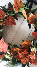 Load image into Gallery viewer, Autumn Wreath Rich russet maple leaves and lush green laurel, sprinkled with wild hydrangeas are stunning on this beautiful Autumn wreath. Looks gorgeous on both light and dark coloured doors. Bring a a touch of Autumn colour to your front door this season. This everlasting wreath can be enjoyed year after year.