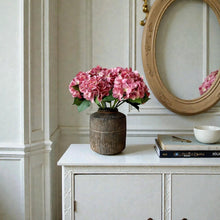 Load image into Gallery viewer, Field &amp; Rose pink artificial silk hydrangea stem, 53cm, styled in a rustic vase.

