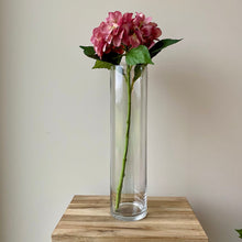 Load image into Gallery viewer, Field &amp; Rose pink artificial hydrangea stem, 53cm, silk flower with green leaves in a clear glass vase.
